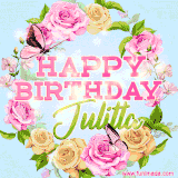 A charming animated GIF featuring 'Happy Birthday Julitta' in pink and green text, surrounded by delicate roses, leaves, and fluttering butterflies on a soft light blue pastel background.