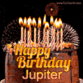 A rich chocolate cake topped with glowing birthday candles and surrounded by bright fireworks. The animated GIF displays the message 'Happy Birthday Jupiter' in golden text.