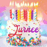 A cheerful white birthday cake with multicolor sprinkles, lit candles, and 'Jurnee' written in vibrant letters, in an animated GIF.