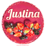 Beautifully decorated red velvet berry birthday cake with vibrant fruits and a glowing 'Justina' name, adding a touch of sweetness and sparkle.