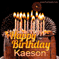 A rich chocolate cake topped with glowing birthday candles and surrounded by bright fireworks. The animated GIF displays the message 'Happy Birthday Kaeson' in golden text.