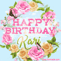 A charming animated GIF featuring 'Happy Birthday Kari' in pink and green text, surrounded by delicate roses, leaves, and fluttering butterflies on a soft light blue pastel background.