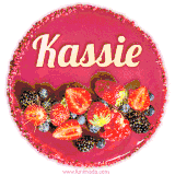 Beautifully decorated red velvet berry birthday cake with vibrant fruits and a glowing 'Kassie' name, adding a touch of sweetness and sparkle.