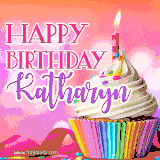 A vibrant birthday GIF featuring a rainbow-colored cupcake topped with white frosting, sprinkles, and a lit candle. The text reads 'Happy Birthday Katharyn' in bold pink and violet letters with white outline.