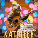 Animated birthday GIF showing a capybara playing guitar and singing beside a birthday cake with the name Kathleen in large letters and colorful bokeh lights in the background.