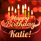 Beautifully decorated red velvet berry birthday cake with vibrant fruits and a glowing 'Katie' name, adding a touch of sweetness and sparkle.