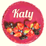 Beautifully decorated red velvet berry birthday cake with vibrant fruits and a glowing 'Katy' name, adding a touch of sweetness and sparkle.