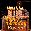 A rich chocolate cake topped with glowing birthday candles and surrounded by bright fireworks. The animated GIF displays the message 'Happy Birthday Kaveer' in golden text.