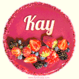 Beautifully decorated red velvet berry birthday cake with vibrant fruits and a glowing 'Kay' name, adding a touch of sweetness and sparkle.