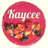 Beautifully decorated red velvet berry birthday cake with vibrant fruits and a glowing 'Kaycee' name, adding a touch of sweetness and sparkle.