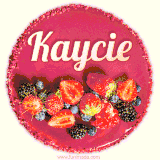 Beautifully decorated red velvet berry birthday cake with vibrant fruits and a glowing 'Kaycie' name, adding a touch of sweetness and sparkle.