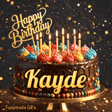 A decorated birthday cake with colorful candy decorations and burning candles on a golden stand, customized for Kayde.