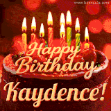 Beautifully decorated red velvet berry birthday cake with vibrant fruits and a glowing 'Kaydence' name, adding a touch of sweetness and sparkle.