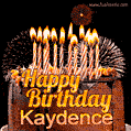 A rich chocolate cake topped with glowing birthday candles and surrounded by bright fireworks. The animated GIF displays the message 'Happy Birthday Kaydence' in golden text.