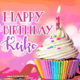 A vibrant birthday GIF featuring a rainbow-colored cupcake topped with white frosting, sprinkles, and a lit candle. The text reads 'Happy Birthday Keiko' in bold pink and violet letters with white outline.
