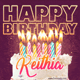A colorful birthday cake topped with lit candles, with the words 'Happy Birthday Keithia' in bold glowing letters on a burgundy background. Animated flames add a festive touch.