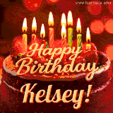 Beautifully decorated red velvet berry birthday cake with vibrant fruits and a glowing 'Kelsey' name, adding a touch of sweetness and sparkle.