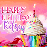 A vibrant birthday GIF featuring a rainbow-colored cupcake topped with white frosting, sprinkles, and a lit candle. The text reads 'Happy Birthday Kelsey' in bold pink and violet letters with white outline.