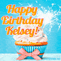 A cheerful animated GIF of a cupcake with creamy frosting, a red checkered ribbon, and a bright sparkler on top. The text 'Happy Birthday Kelsey!' is displayed in vibrant orange and red.
