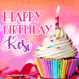 A vibrant birthday GIF featuring a rainbow-colored cupcake topped with white frosting, sprinkles, and a lit candle. The text reads 'Happy Birthday Kesi' in bold pink and violet letters with white outline.