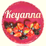 Beautifully decorated red velvet berry birthday cake with vibrant fruits and a glowing 'Keyanna' name, adding a touch of sweetness and sparkle.