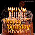 A rich chocolate cake topped with glowing birthday candles and surrounded by bright fireworks. The animated GIF displays the message 'Happy Birthday Khaden' in golden text.