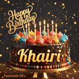 Bold golden lettering spelling Khairi on a gourmet chocolate cake decorated with small colorful candies at the base.