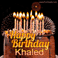 A rich chocolate cake topped with glowing birthday candles and surrounded by bright fireworks. The animated GIF displays the message 'Happy Birthday Khaled' in golden text.