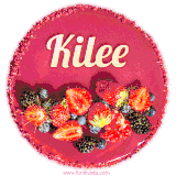 Beautifully decorated red velvet berry birthday cake with vibrant fruits and a glowing 'Kilee' name, adding a touch of sweetness and sparkle.