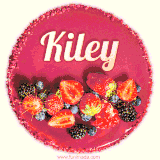 Beautifully decorated red velvet berry birthday cake with vibrant fruits and a glowing 'Kiley' name, adding a touch of sweetness and sparkle.