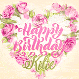 A stunning heart made of pink roses surrounds the elegant script text 'Happy Birthday Kilie' on a soft beige background. Animated sparkles add a magical and festive feel.