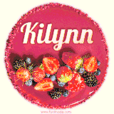 Beautifully decorated red velvet berry birthday cake with vibrant fruits and a glowing 'Kilynn' name, adding a touch of sweetness and sparkle.