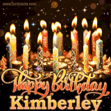 A glowing personalized birthday GIF with name Kimberley featuring lit candles with intricate designs, warm lighting, and the text 'Happy Birthday' in an elegant font.