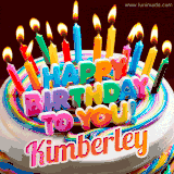 A colorful birthday cake topped with lit candles, with the words 'Happy Birthday Kimberley' in bold glowing letters on a burgundy background. Animated flames add a festive touch.