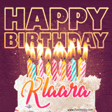 A colorful birthday cake topped with lit candles, with the words 'Happy Birthday Klaara' in bold glowing letters on a burgundy background. Animated flames add a festive touch.