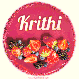 Beautifully decorated red velvet berry birthday cake with vibrant fruits and a glowing 'Krithi' name, adding a touch of sweetness and sparkle.