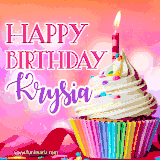 A vibrant birthday GIF featuring a rainbow-colored cupcake topped with white frosting, sprinkles, and a lit candle. The text reads 'Happy Birthday Krysia' in bold pink and violet letters with white outline.