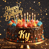 Bold golden lettering spelling Ky on a gourmet chocolate cake decorated with small colorful candies at the base.
