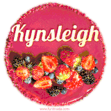 Beautifully decorated red velvet berry birthday cake with vibrant fruits and a glowing 'Kynsleigh' name, adding a touch of sweetness and sparkle.