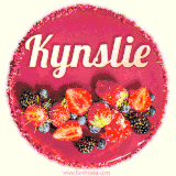 Beautifully decorated red velvet berry birthday cake with vibrant fruits and a glowing 'Kynslie' name, adding a touch of sweetness and sparkle.