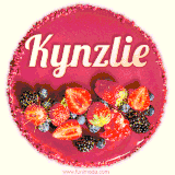 Beautifully decorated red velvet berry birthday cake with vibrant fruits and a glowing 'Kynzlie' name, adding a touch of sweetness and sparkle.