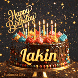 Bright candles flickering on a festive chocolate cake with the name Lakin displayed in golden letters.