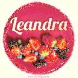 Beautifully decorated red velvet berry birthday cake with vibrant fruits and a glowing 'Leandra' name, adding a touch of sweetness and sparkle.