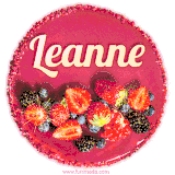 Beautifully decorated red velvet berry birthday cake with vibrant fruits and a glowing 'Leanne' name, adding a touch of sweetness and sparkle.