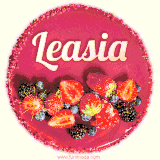 Beautifully decorated red velvet berry birthday cake with vibrant fruits and a glowing 'Leasia' name, adding a touch of sweetness and sparkle.