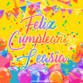 A bright and festive GIF with the text 'Feliz Cumpleaños Leasia' in Spanish in colorful fonts, surrounded by confetti, balloons, and festive banners on a vibrant yellow background.
