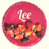 Beautifully decorated red velvet berry birthday cake with vibrant fruits and a glowing 'Lee' name, adding a touch of sweetness and sparkle.