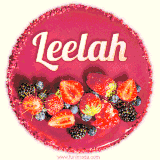 Beautifully decorated red velvet berry birthday cake with vibrant fruits and a glowing 'Leelah' name, adding a touch of sweetness and sparkle.