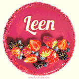 Beautifully decorated red velvet berry birthday cake with vibrant fruits and a glowing 'Leen' name, adding a touch of sweetness and sparkle.
