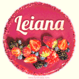 Beautifully decorated red velvet berry birthday cake with vibrant fruits and a glowing 'Leiana' name, adding a touch of sweetness and sparkle.